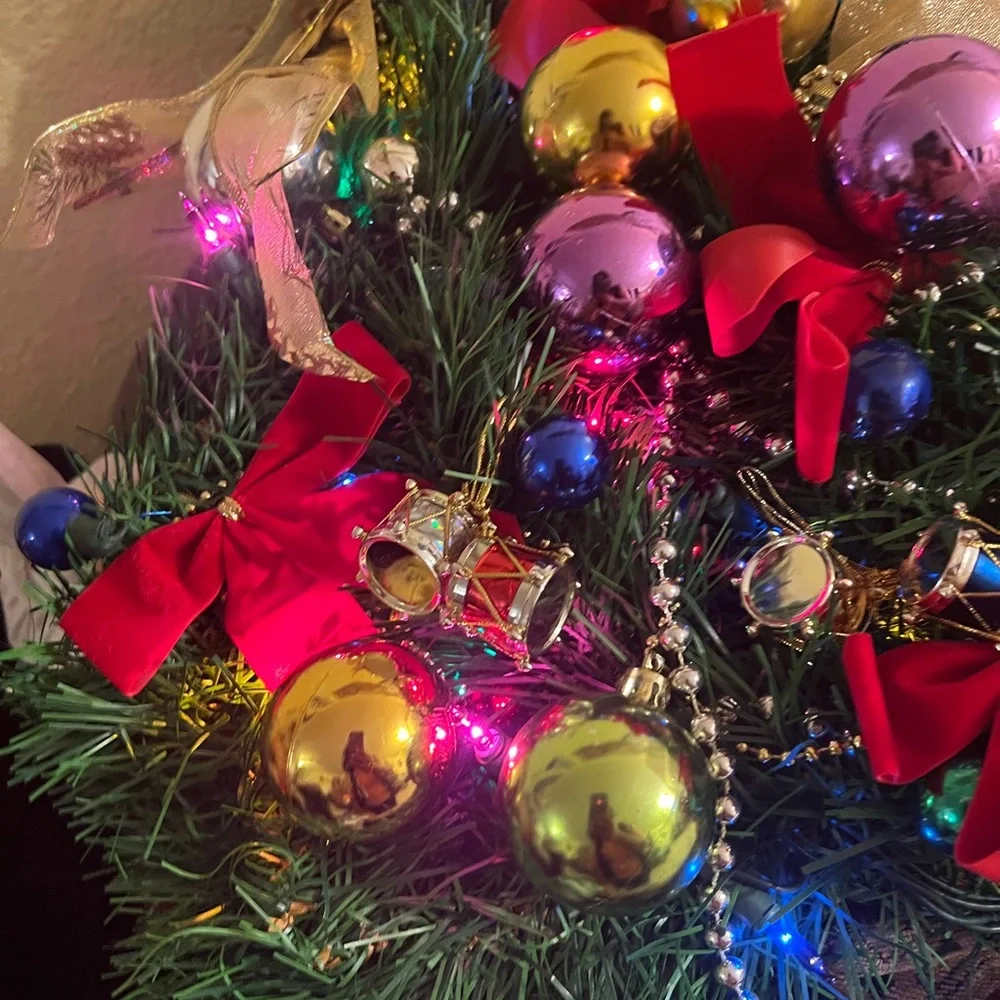 Festive Holiday Wreath with Gold Bow and Multicolor Ornaments